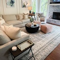 a living room filled with furniture and a flat screen tv mounted on the wall above a fireplace