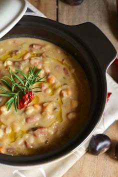 a pot filled with soup sitting on top of a wooden table