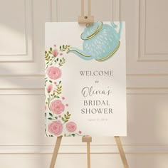 a welcome sign for a bridal shower with pink flowers and a teapot on it