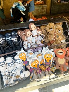 star wars themed stuffed animals are for sale in a market stall with other items on display