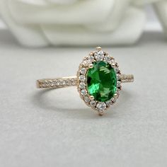 This beautiful ring is made from genuine 925 sterling silver with rose gold plating. Engagement Ring details- -The Main stone is an oval cut 8mm by 6mm Lab Created Nano Emerald Stone -Side stones are Round 1.2MM-2MM simulated diamonds -Ring is cast in solid 925 sterling silver with rose gold plating (yellow gold and rhodium plated also available, please check the drop down menu for more options) -The Total face height of the ring measures 10mms and the band width measures 1.5mms -Each ring is ha Formal Rose Gold Ring For May Birthstone, Classic Rose Gold Emerald Ring For Anniversary, Formal Rose Gold Emerald Ring With Halo Setting, Rose Gold Jewelry With Halo Setting For May Birthstone, Fine Jewelry Rose Gold Ring For May Birthstone, Rose Gold Halo Design Ring As Gift, Rose Gold Rings With Halo Design For Gift, Rose Gold Emerald Ring With Halo Setting For Anniversary, Rose Gold Diamond Ring For May Birthstone Gift