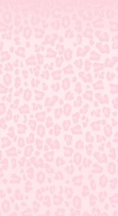 a pink leopard print wallpaper with white and black spots on the bottom half of it