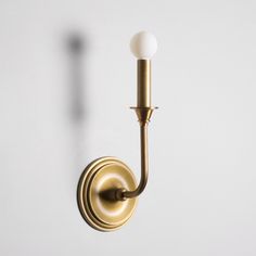 a wall light with a white ball on the side and a long arm that is attached to it