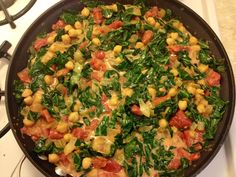 a pan filled with vegetables on top of a stove