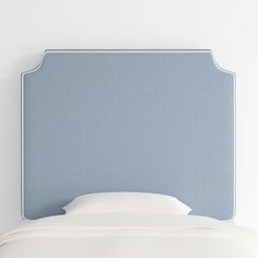 a blue headboard with white sheets and pillows on it's sides, against a white wall