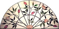 a circular stained glass window with flowers and leaves on the outside, in front of a white background