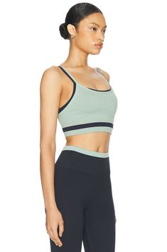 52% polyester 40% recycled polyamide 8% elastane.  Made in China.  Machine wash.  Unpadded cups.  Contrast fabric overlay.  Item not sold as a set.  .  .  .  .  .  .  .  .  .  . Versatile Workout Tops, Micro-elastic Sportswear Tops For Yoga, Micro-elastic Moisture-wicking Athleisure Top, Moisture-wicking Micro-elastic Athleisure Top, Micro-elastic Go-dry Top For Workout, Sports Tops With Built-in Bra, Micro-elastic Elastane Tops With Moisture-wicking, Micro-elastic Moisture-wicking Elastane Tops, Moisture-wicking Micro-elastic Elastane Top