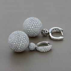 A magical pair of earrings featuring 12.80 carats of VS quality round cut diamonds set into 18K white gold spheres. The spheres, which are completely covered in diamond pave, spin and rotate freely from the drop adding movement to the piece. A special pair of earrings, quality craft.    Dimensions: 1.40 x 0.50 inches Luxury Drop Earrings With Pave Setting, Luxury Round Cut Sparkling Diamond Earrings, Luxury Silver Diamond Earrings With Pave Setting, Luxury Sparkling Round Cut Diamond Earrings, Luxury Diamond White Diamond Earrings With Sparkling Stones, Silver Drop Earrings With Pave Setting, Luxury Round Diamond Earrings With Sparkling Stones, Luxury Round Earrings With Sparkling Stones, Gold Drop Earrings