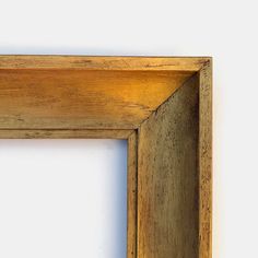 an empty wooden frame on a white wall