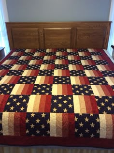 a bed with an american flag quilt on it