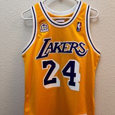 a basketball jersey hanging on a wall with the number 24 on it's chest