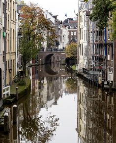 a river running through a city next to tall buildings