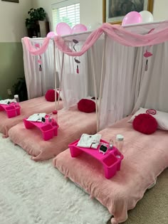 three beds with pink and white decorations on them