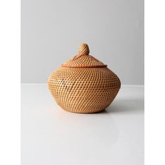 a basket with lid sitting on top of a table