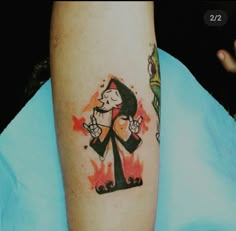 a person with a cartoon tattoo on their arm and leg, holding a toothbrush