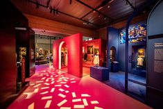 an exhibit room with red and blue walls