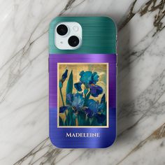 an iphone case with blue irises on it sitting on a marble countertop next to a phone charger