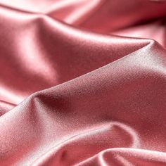 a close up view of a pink satin fabric