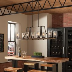 a dining room table with wine glasses and bottles on the top shelf next to it