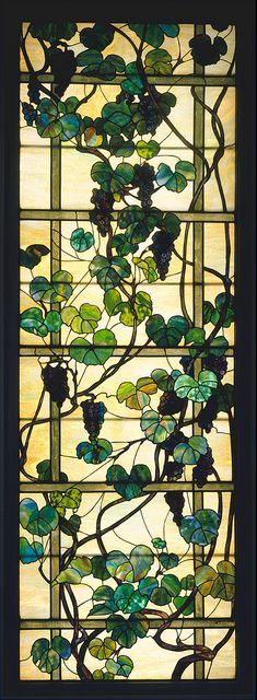 a stained glass window with vines and leaves