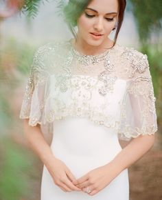 a woman wearing a white dress and veil