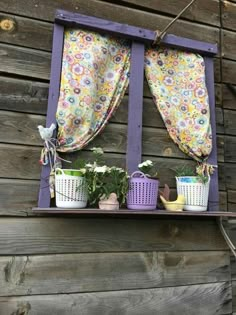 an old window is decorated with flowers and potted plants