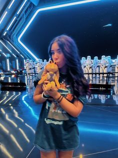 a girl holding a stuffed animal in front of a star wars scene