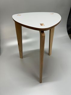 a white table sitting on top of a white floor