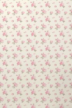 a pink flowered wallpaper with small flowers on it's side and green leaves