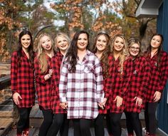 a group of women wearing red and black flannel