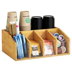 a wooden cup holder with coffee cups and other items in it