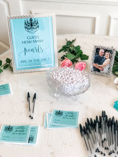 a table topped with lots of different types of pens and magnets on top of it