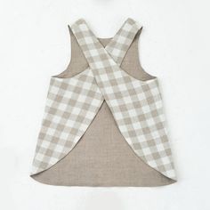 an apron made out of fabric on top of a white wall