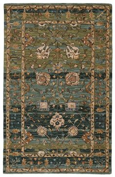 a green rug with an ornate design on the bottom and sides, in various colors