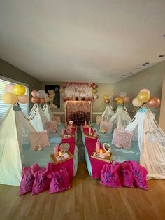 a room filled with lots of pink bags and balloons