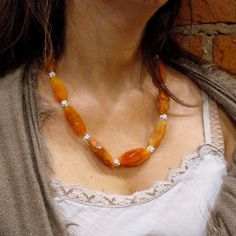 "This is a stunning statement necklace. Orange and light brown tone druzy agate stones create a very unique piece. Agate's most noticeable properties overall are balancing yin/yang energy, courage, protection, healing, and calming. Historically it was placed in water for cooking or drinking to dispel sickness. The Metaphysical and Healing Properties Lore of any specific type of agate depend to some extent on the color of the agate, but all agates have certain things in common. Agate is a stone o Orange Statement Necklace, Necklace Stones, Orange Necklace, Stones Necklace, Orange Agate, Necklace Stone, Druzy Necklace, Druzy Quartz, Agate Necklace