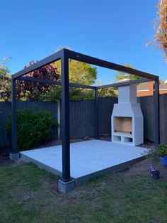 an outdoor fireplace in the middle of a yard