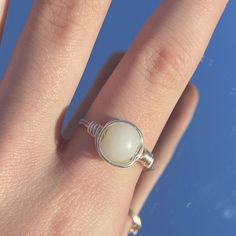 white wired ring! Everyday White Hand-wrapped Jewelry, Adjustable White Crystal Ring Gift, Adjustable White Crystal Ring For Gifts, Minimalist Handmade White Moonstone Ring, Adjustable White Wire Wrapped Jewelry, Adjustable Wire Wrapped White Jewelry, Handmade Adjustable White Rings, Minimalist Adjustable White Pearl Ring, Nickel Free White Round Ring