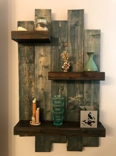 two wooden shelves with vases and other items on them