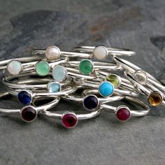 Create your own unique set of stacking rings. Select a stacking ring to represent your birthday or the birthdays of the ones you love. Or, create your own colorful set by mixing and matching your favorite colors and gemstones. The gems are 4mm. Set in solid sterling silver. Birthstone: January - Garnet February - Amethyst March - Aquamarine April - Clear Topaz May - Green Onyx June - Pearl July - Lab Ruby August - Peridot September - Lab Sapphire October - Lab Opal November - Citrine December - Sterling Silver Stackable Rings, May Birthstone Gift, Handmade Adjustable Stackable Rings With Round Band, Stackable Sterling Silver Jewelry For Birthdays, Sterling Silver Stackable Jewelry For Birthday, Birthday Stackable Sterling Silver Jewelry, Adjustable Bezel Setting Midi Rings As Gift, Adjustable Bezel Setting Midi Rings For Gift, Stackable Round Jewelry For Birthday, Adjustable Spiritual Stackable Rings As Gift