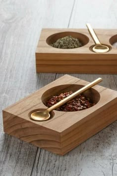 two wooden bowls with spoons in them