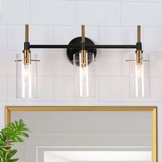 a bathroom vanity light with three lights on it