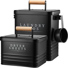 two black storage boxes with wooden handles and labels on the sides, one for laundry dispensers