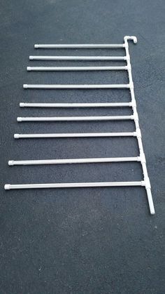 a set of seven metal clothes pins on a black surface