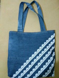 a blue bag with white lace on it