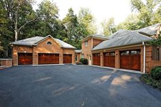 two garages with brown doors are in the driveway