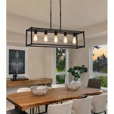 a dining room table and chairs with lights hanging from the chandelier over it