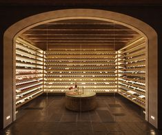 the wine cellar is very large and well stocked with many rows of bottles in it