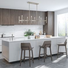 a kitchen with two bar stools next to a counter top and an island in the middle