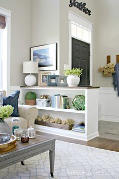 a living room filled with lots of furniture and decor on top of a wooden table